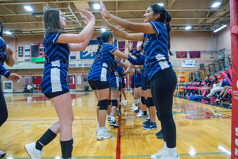The CE Rose girls volleyball team exchanges high fives