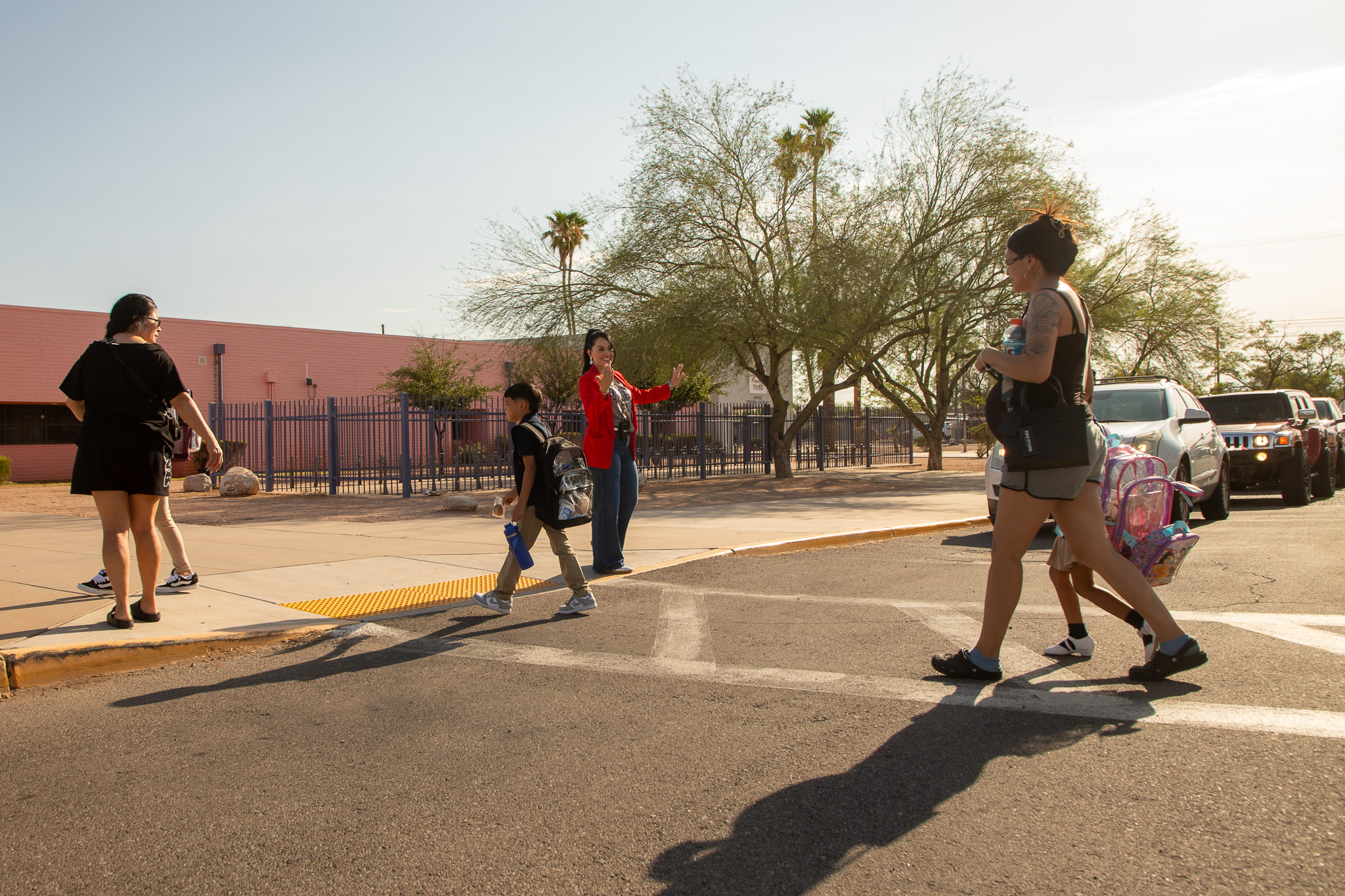 Families walk in the crosswalk on the second day of school