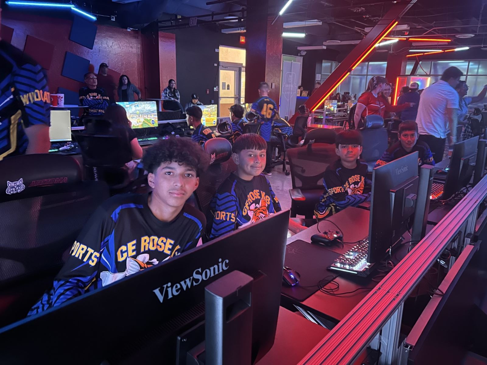 Students pose in front of their computers