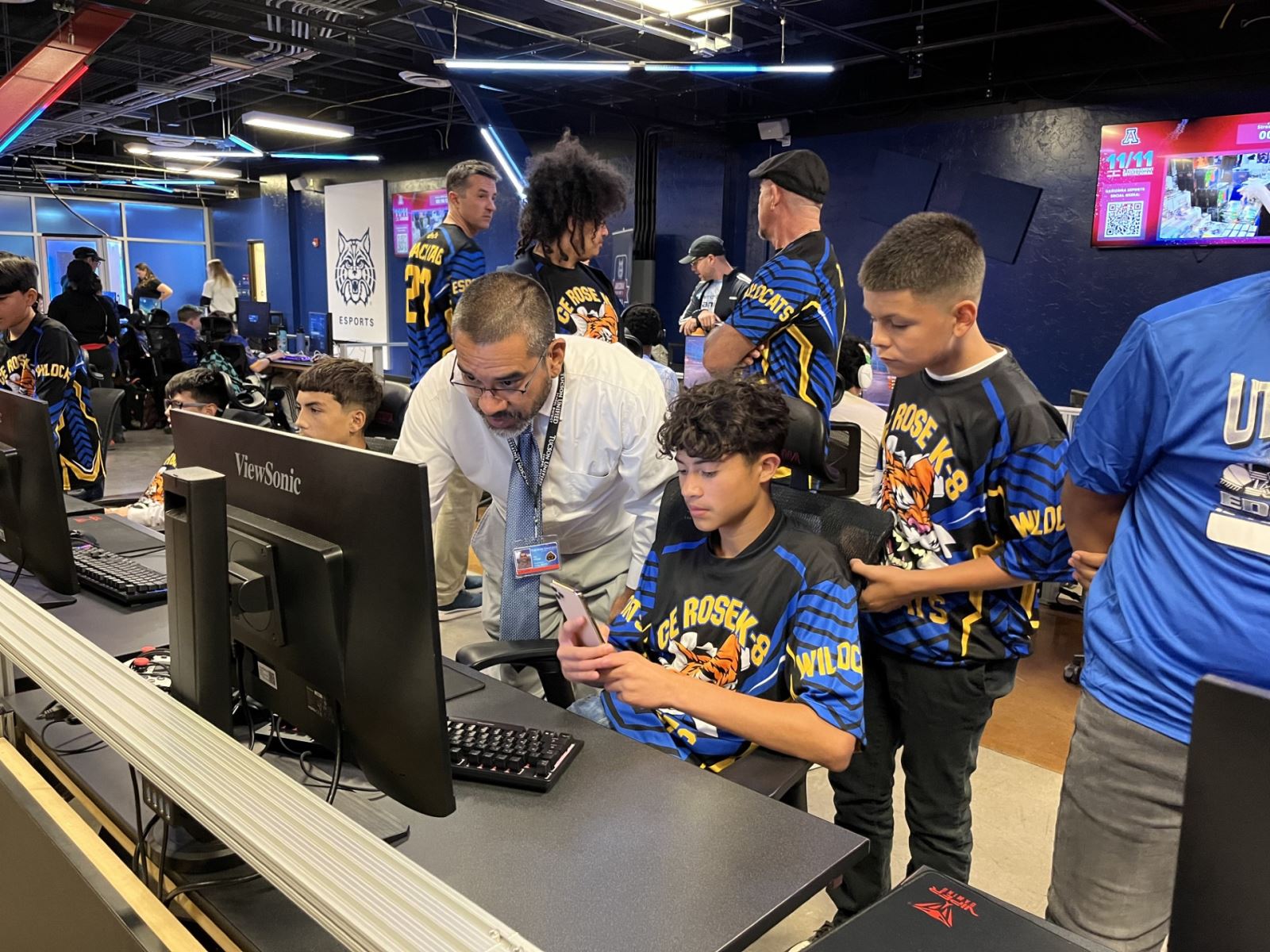 A teacher assists students during the event.