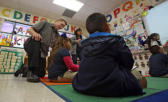 photo of students with prinicipal in classroom